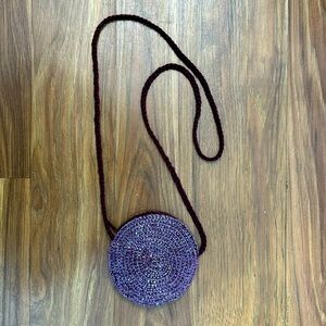 Small, purple, sequin bag. Space for money or small makeup items.